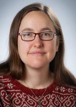 photo of Katelyn Browne, a white librarian with glasses and long brown hair